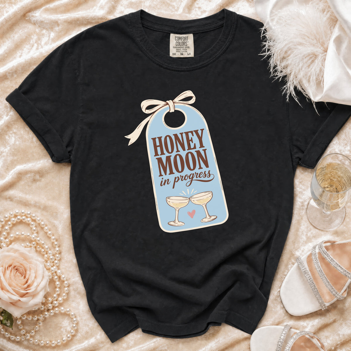 Black t-shirt with "HONEY MOON in progress" text and champagne glasses graphic.