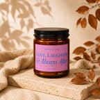 Amber glass candle with pink label reading "Smells Like Love, Laughter & Always After".