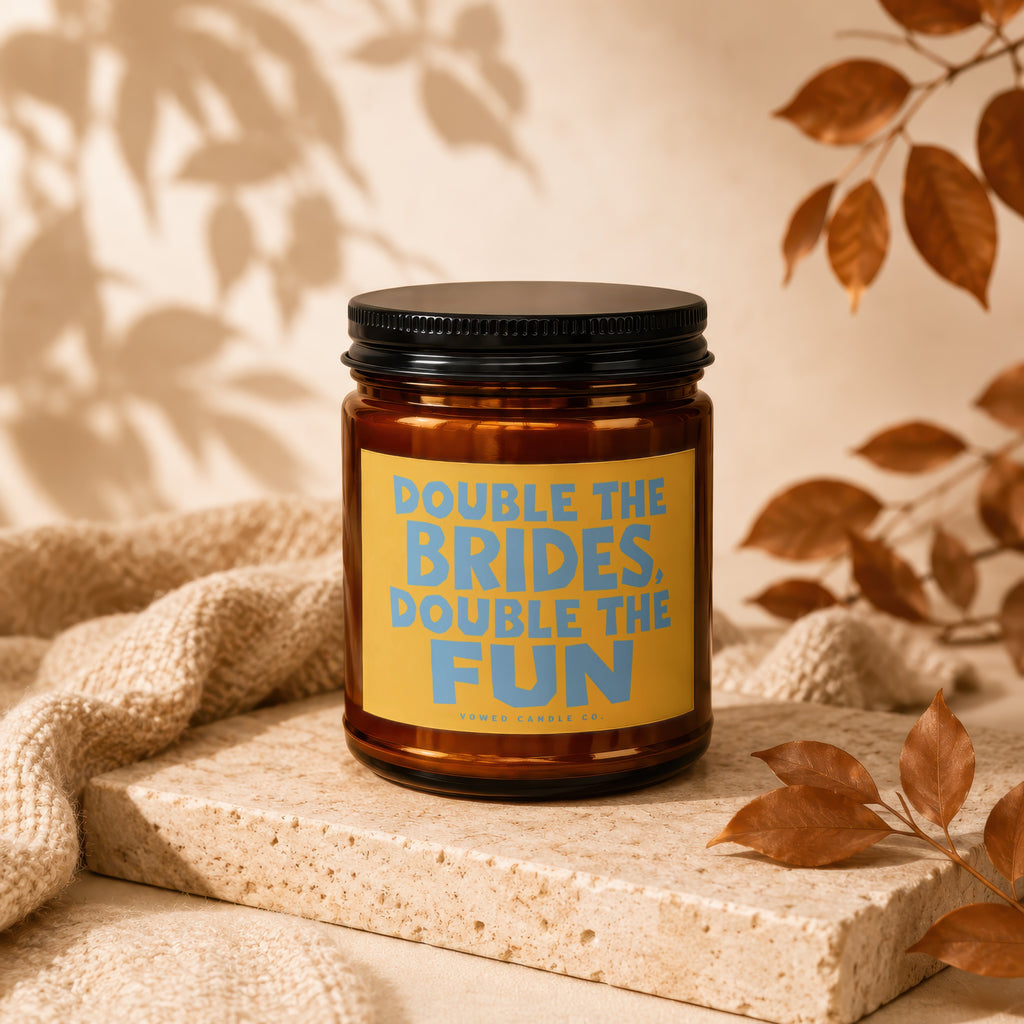 Amber candle with yellow label saying "Double the Brides. Double the Fun."