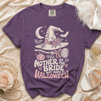 Purple t-shirt with "Mother of the Bride but Make it Halloween" graphic and Halloween elements.