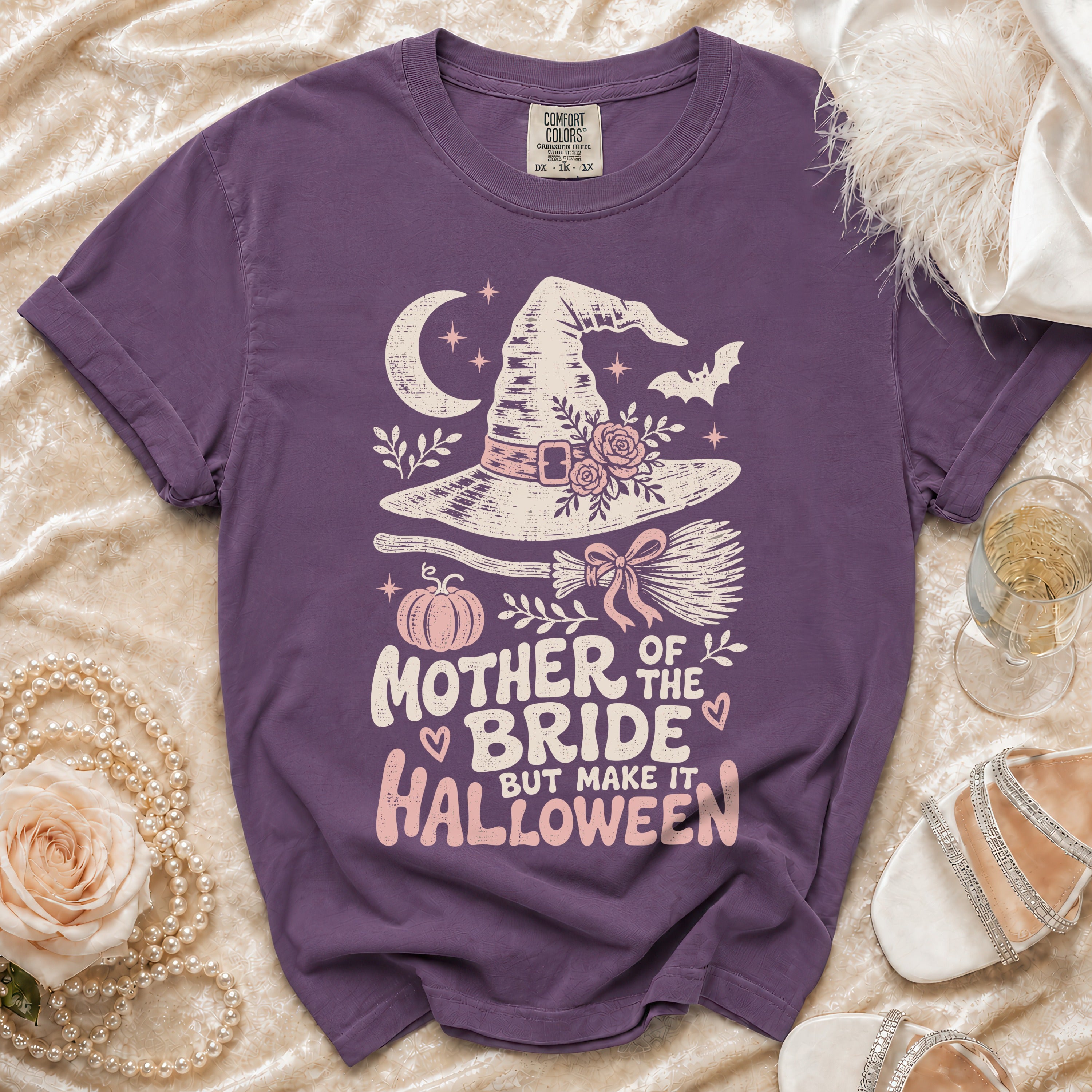 Purple t-shirt with "Mother of the Bride but Make it Halloween" graphic and Halloween elements.
