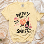 Yellow t-shirt with "Wifey Wants a Spritz" graphic, prosecco bottle, and cocktail.