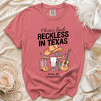 T-shirt with "Olivia's Bach Reckless in Texas" text, cow skull, cowboy boots, guitar, disco ball.