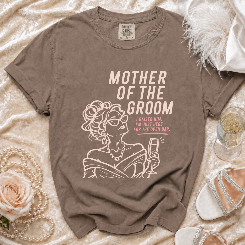 Brown t-shirt with "MOTHER OF THE GROOM I RAISED HIM. I'M JUST HERE FOR THE OPEN BAR" text.