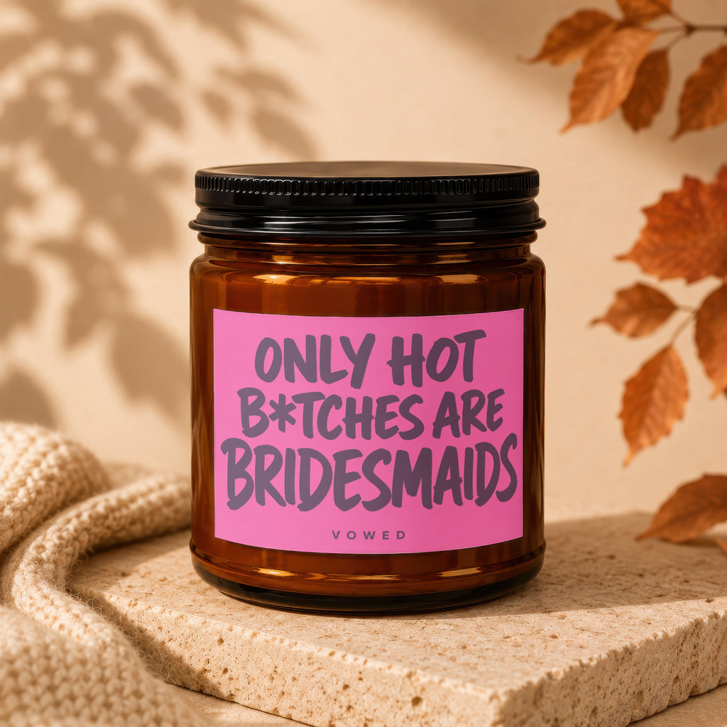 Amber jar candle with pink label reading "ONLY HOT B*TCHES ARE BRIDESMAIDS"