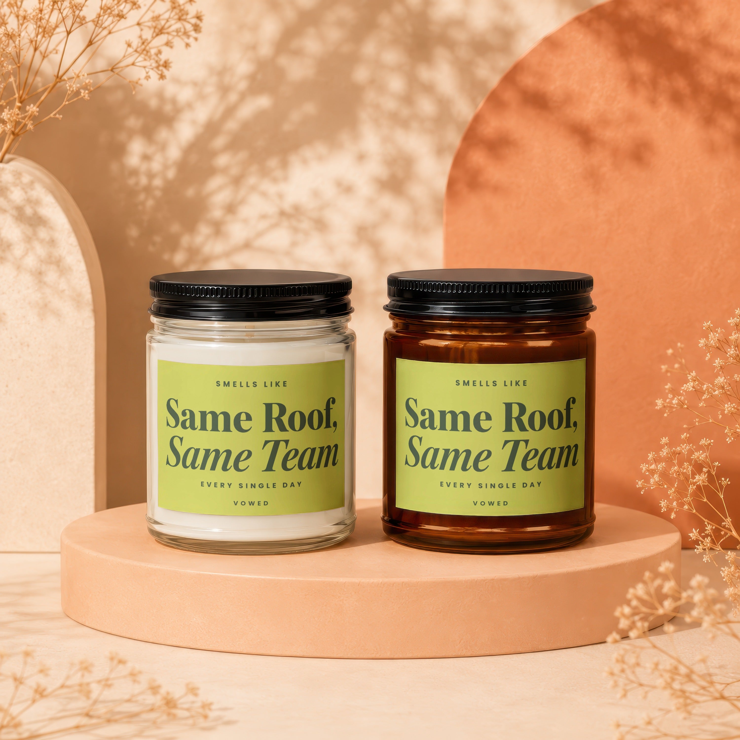 Two candles with black lids, labeled "Same Roof, Same Team."
