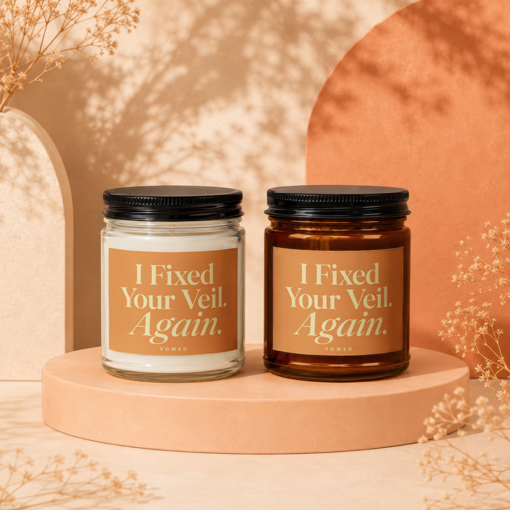 Two candles with labels reading "I Fixed Your Veil. Again. VOWED" on display.