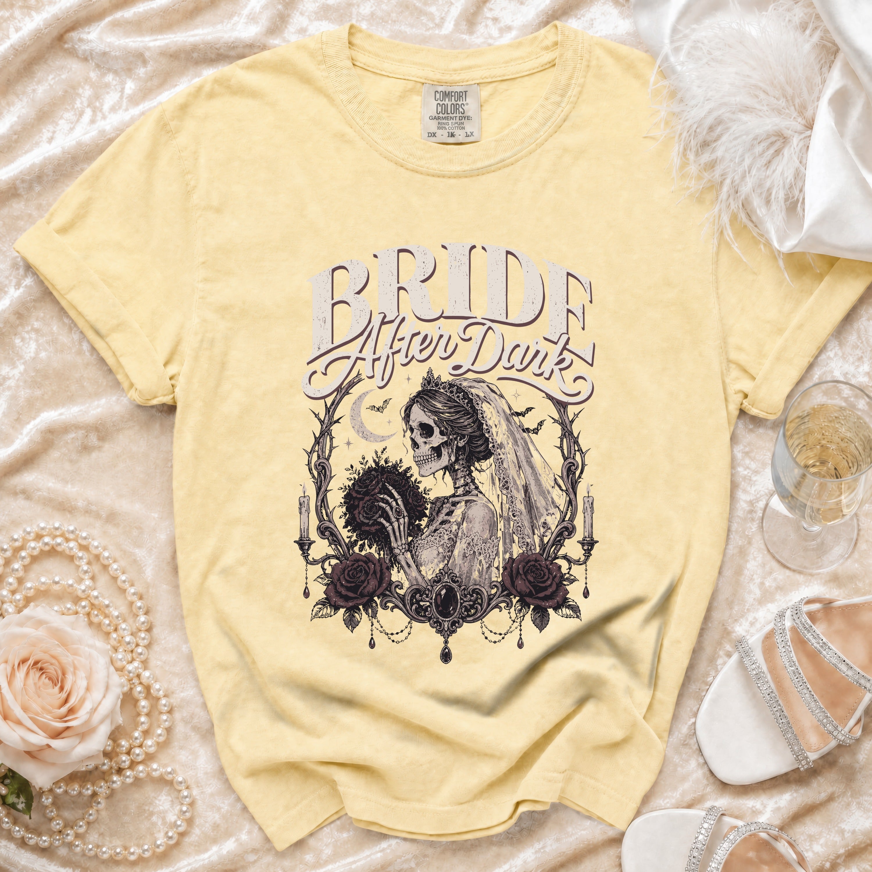Yellow t-shirt with "Bride After Dark" graphic of skeleton bride holding flowers.