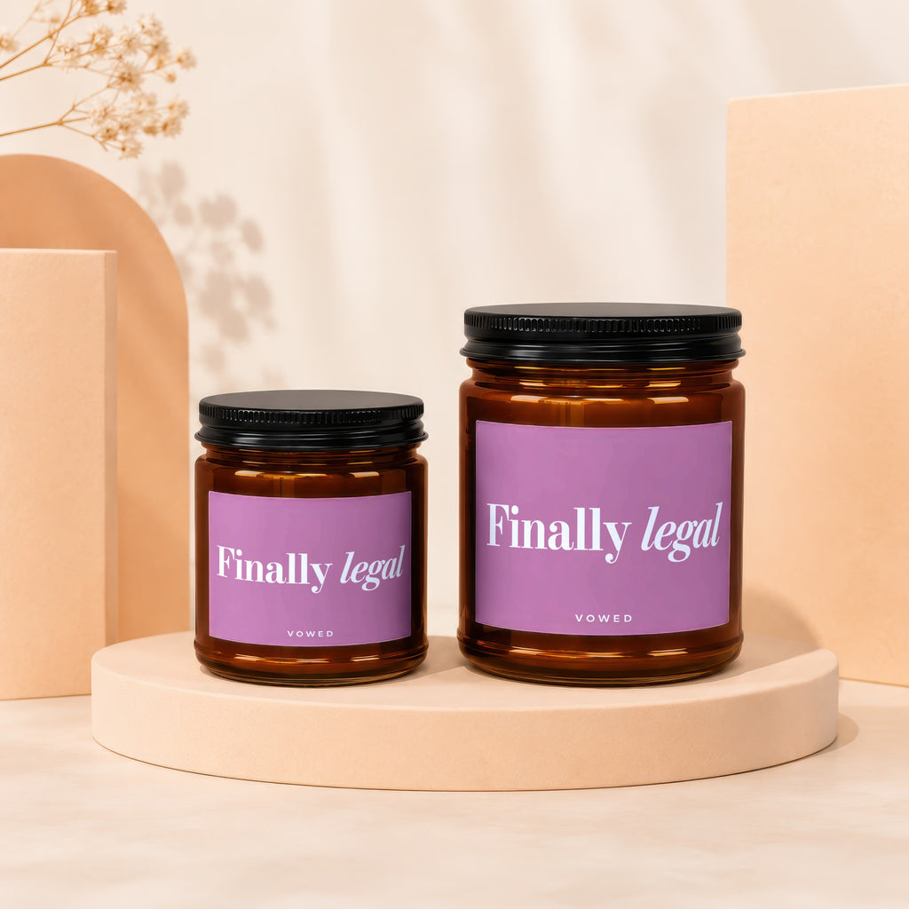 Two amber glass candles with black lids and purple labels saying "Finally legal".