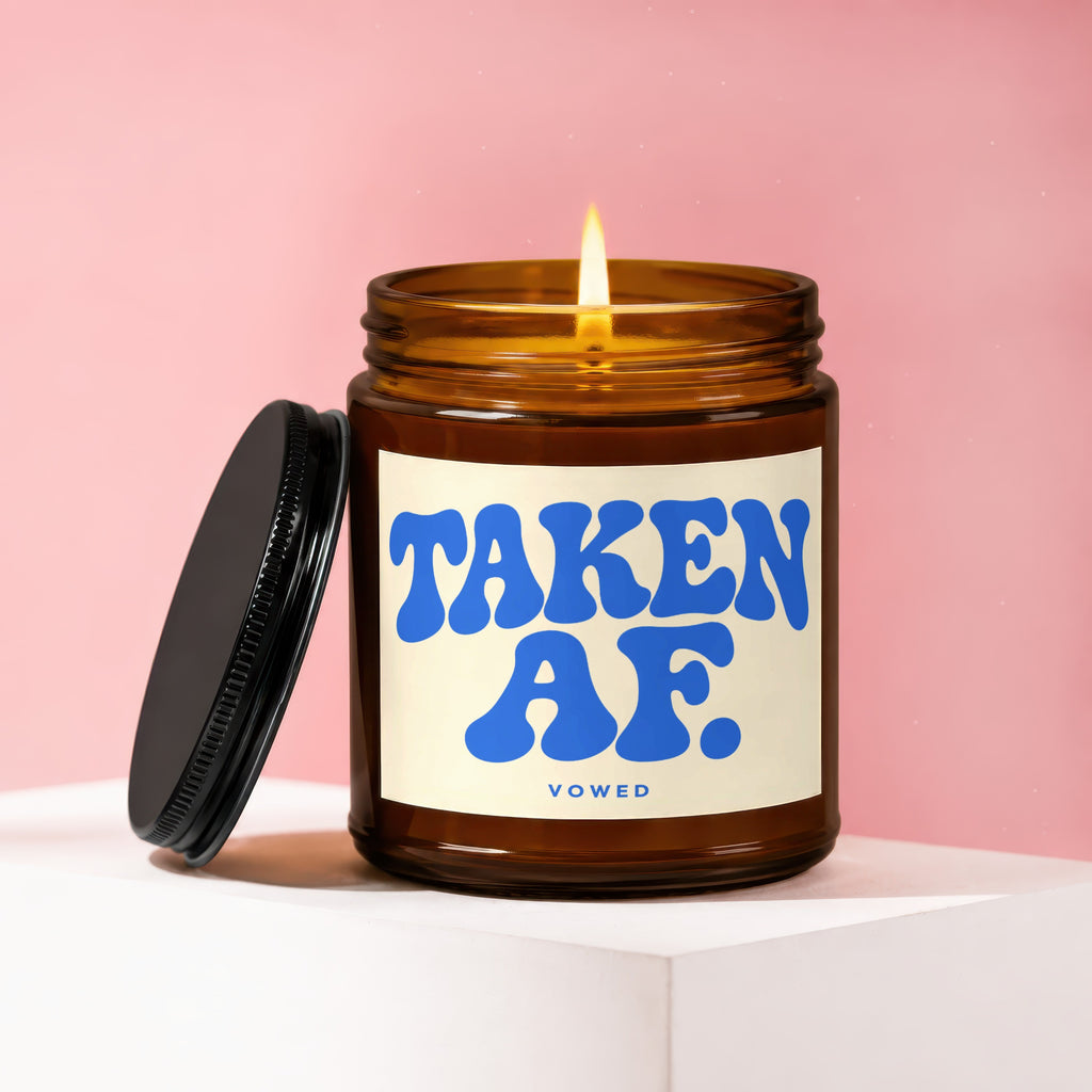 Amber candle with "TAKEN AF." and "VOW