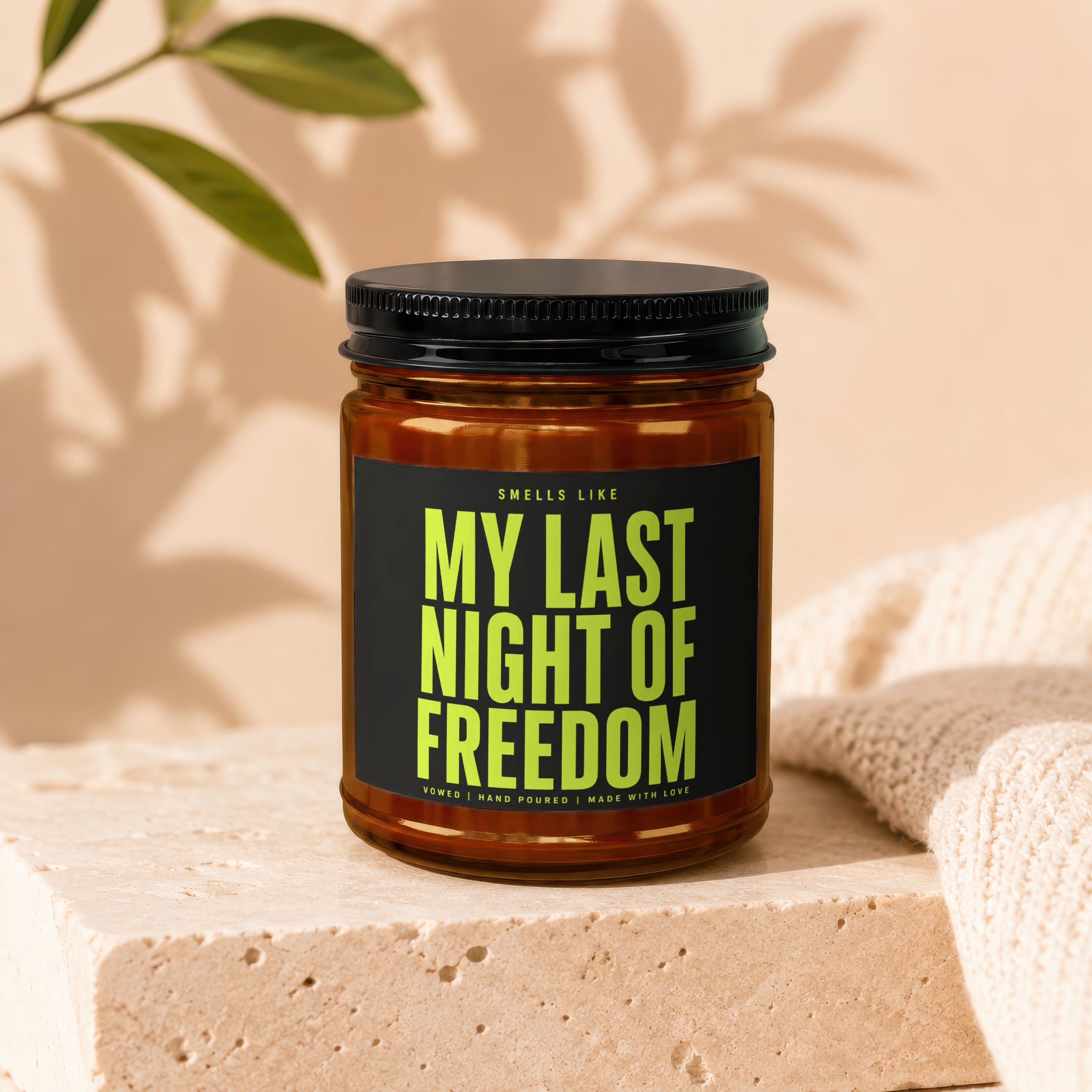 Scented candle with black lid reading "My Last Night of Freedom."