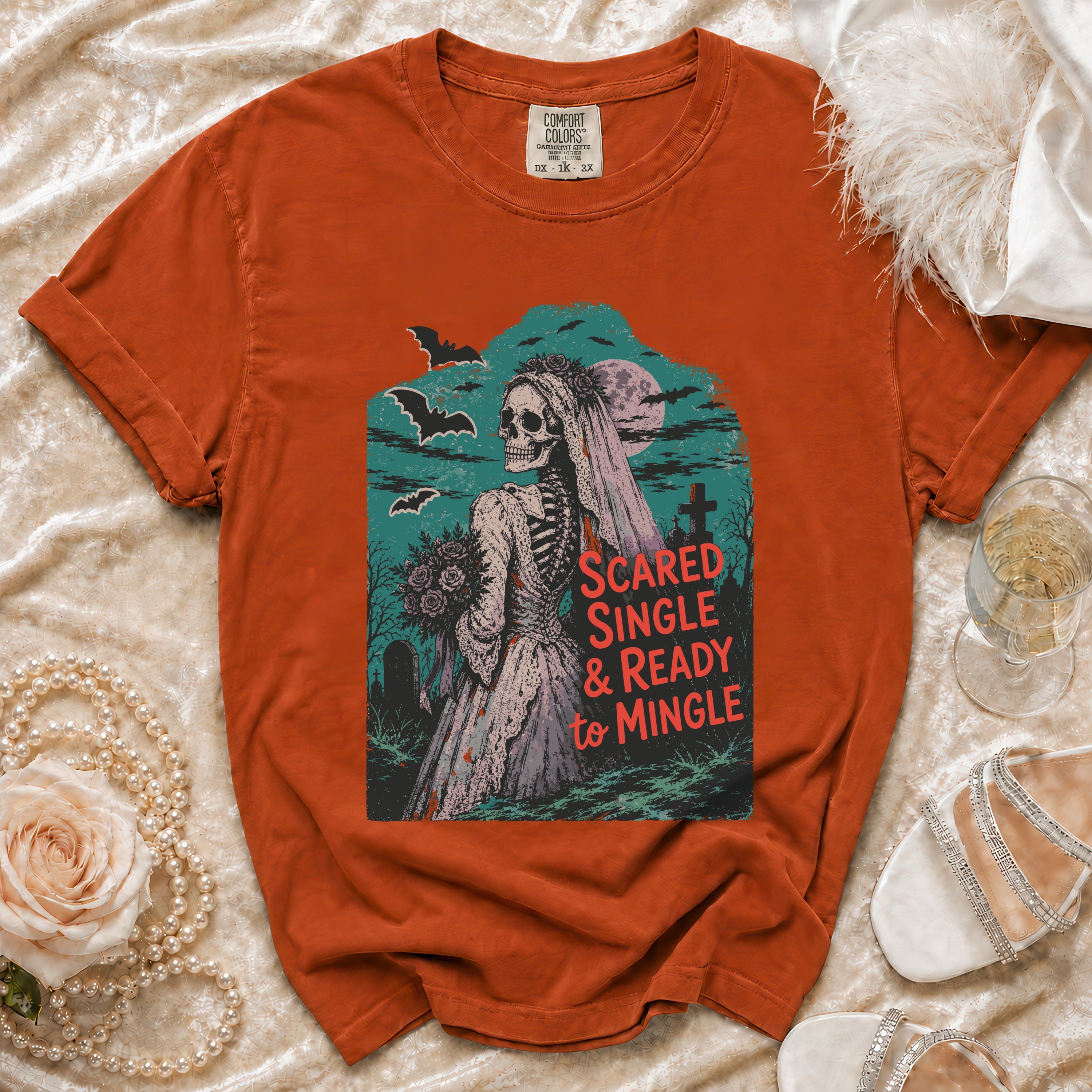 Orange t-shirt with skeleton bride graphic and text "Scared Single & Ready to Mingle".