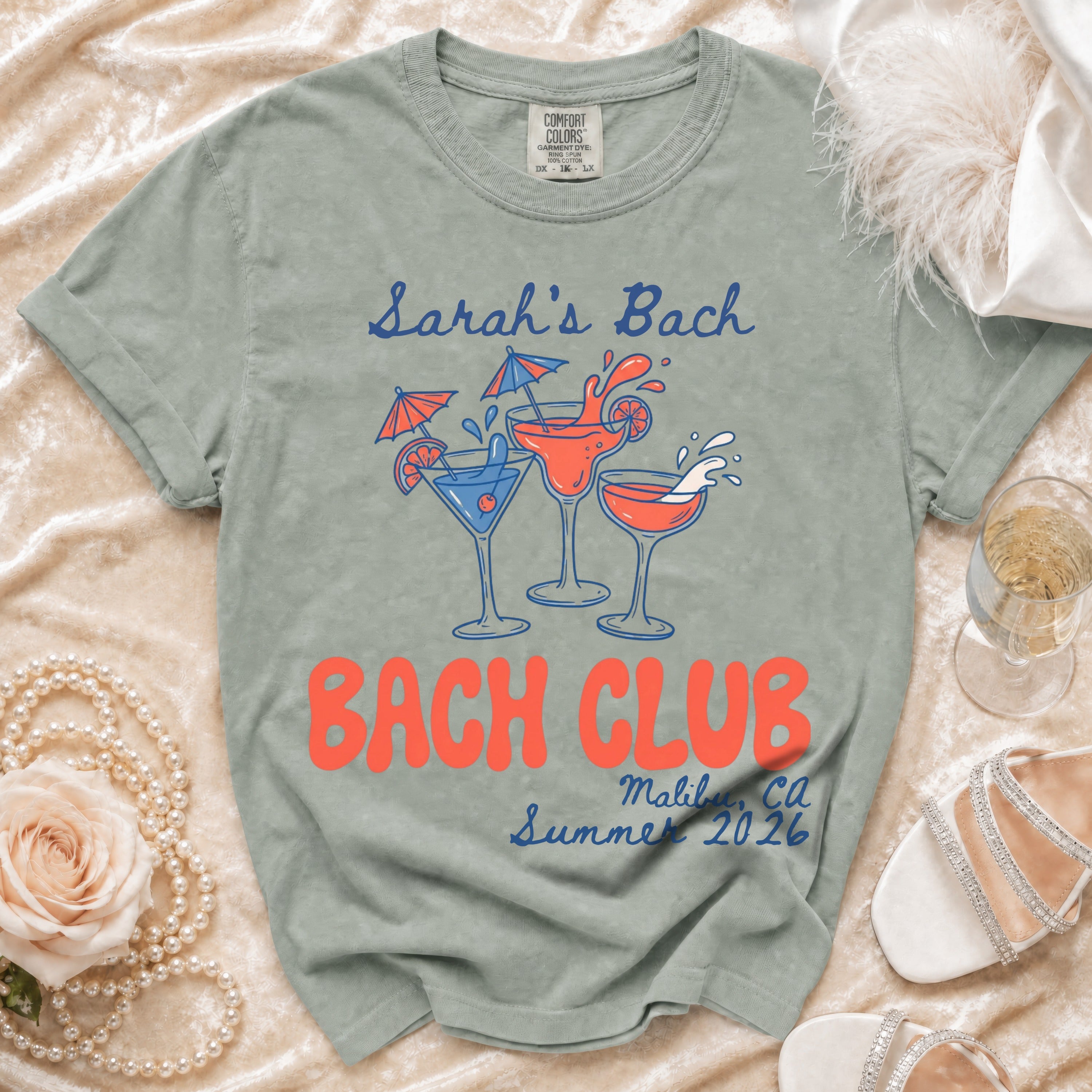 Sage green t-shirt with "Sarah's Bach" and "Bach Club Malibu, Ca Summer 2026" text.