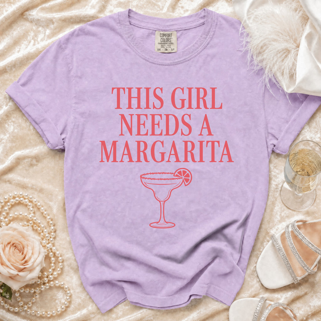 Purple t-shirt with "This Girl Needs A Margarita" text and margarita graphic.