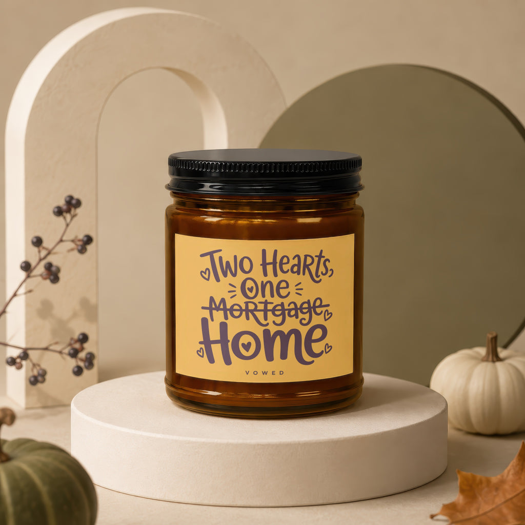 Candle with "Two Hearts, One Mortgage Home" text on label.