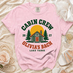 Pink t-shirt with "Cabin Crew Olivia's Bach Lake Tahoe" text and cabin graphic.