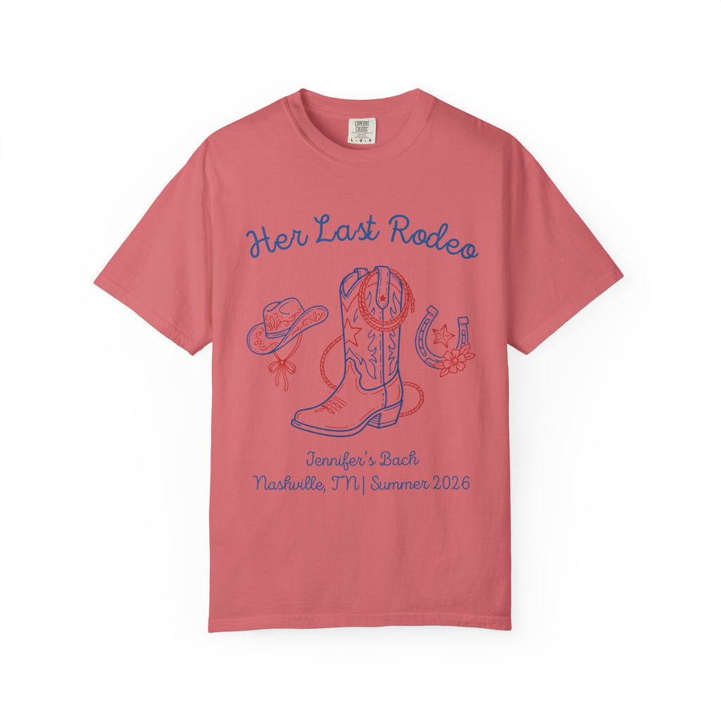 Coral t-shirt with "Her Last Rodeo" text, cowboy boot, hat, and horseshoes.