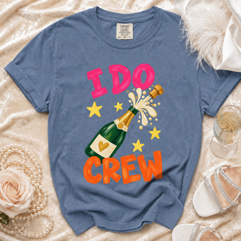 Blue t-shirt with "I DO CREW" text and champagne bottle graphic.