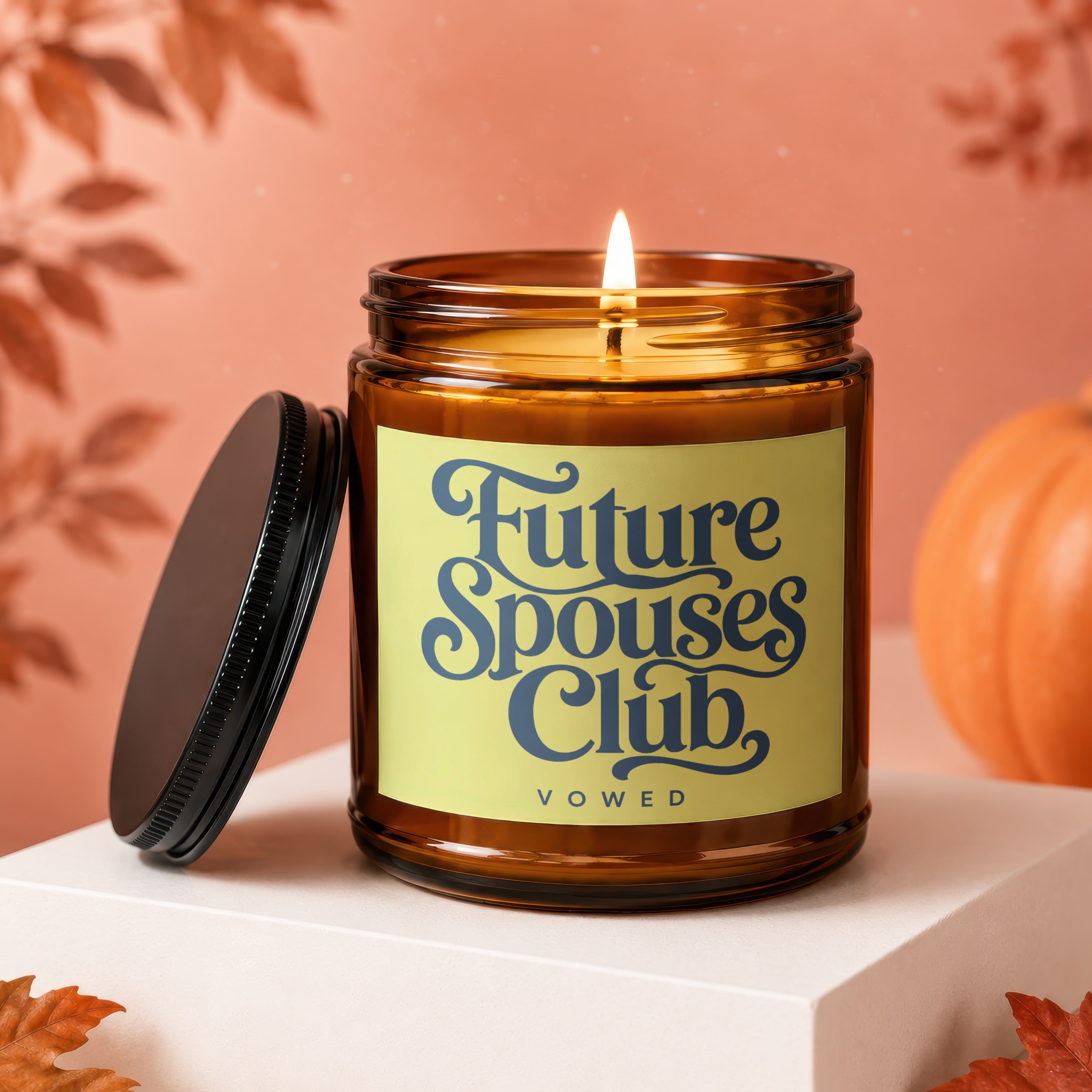 Amber glass candle with lit wick and "Future Spouses Club VOWED" label.