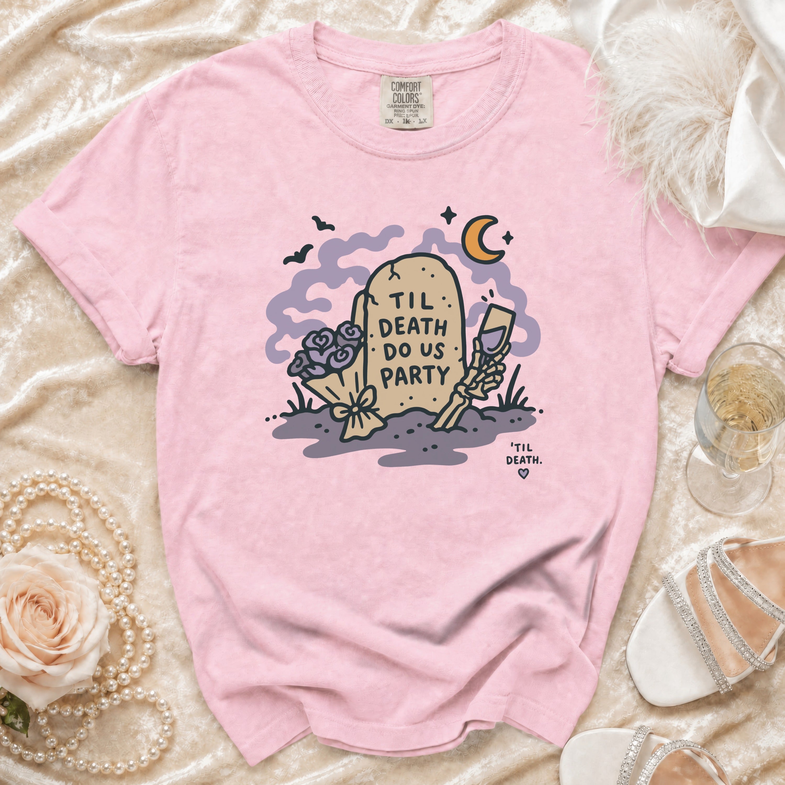 Pink t-shirt with tombstone graphic reading "Til Death Do Us Party".