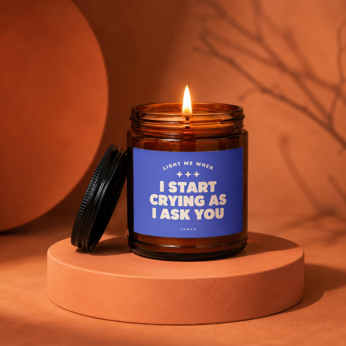 Amber jar candle with blue label reading "Light me when I start crying as I ask you".