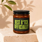 Amber jar candle with black lid and "Best B*tch Officially Vowed" text.