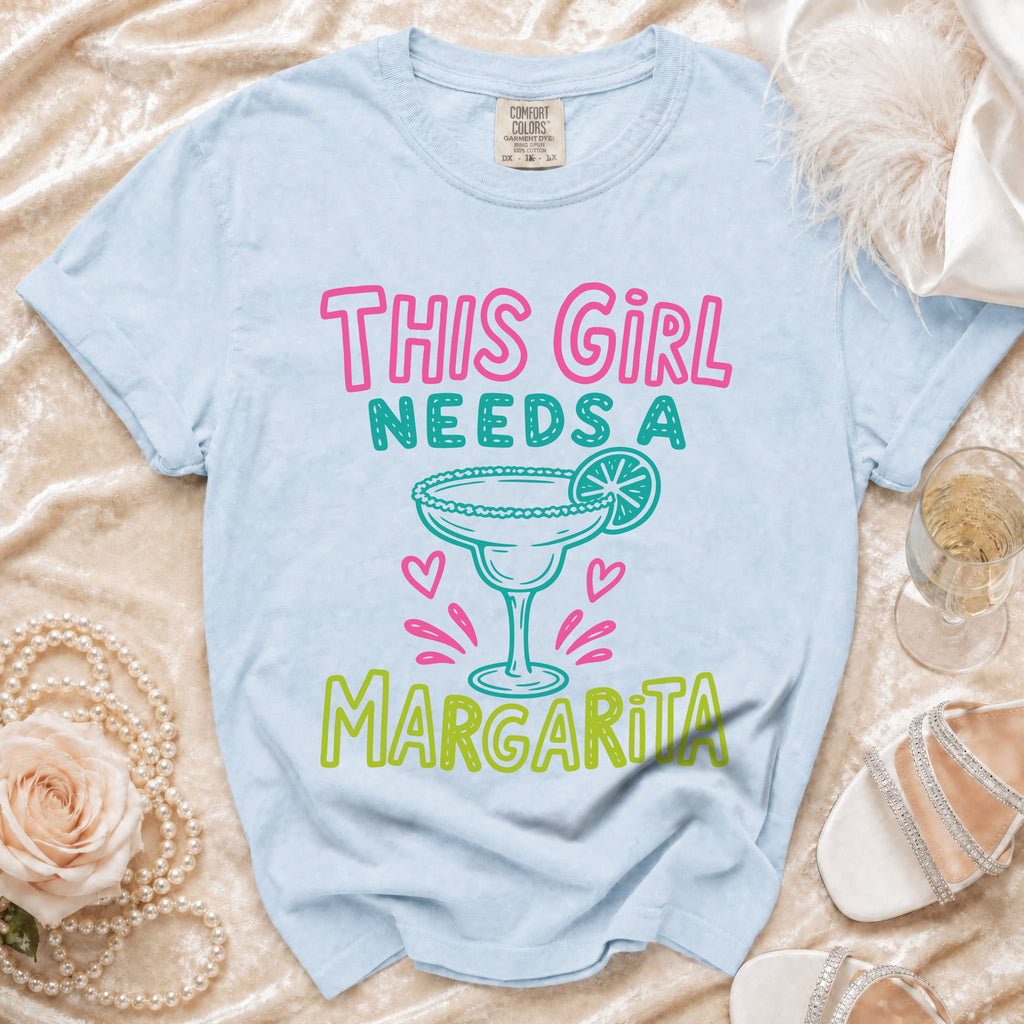 Light blue t-shirt with "THIS GIRL NEEDS A MARGARITA" graphic.
