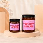 Two amber glass candles with pink labels reading "Wedding planning may cause loss of sleep".