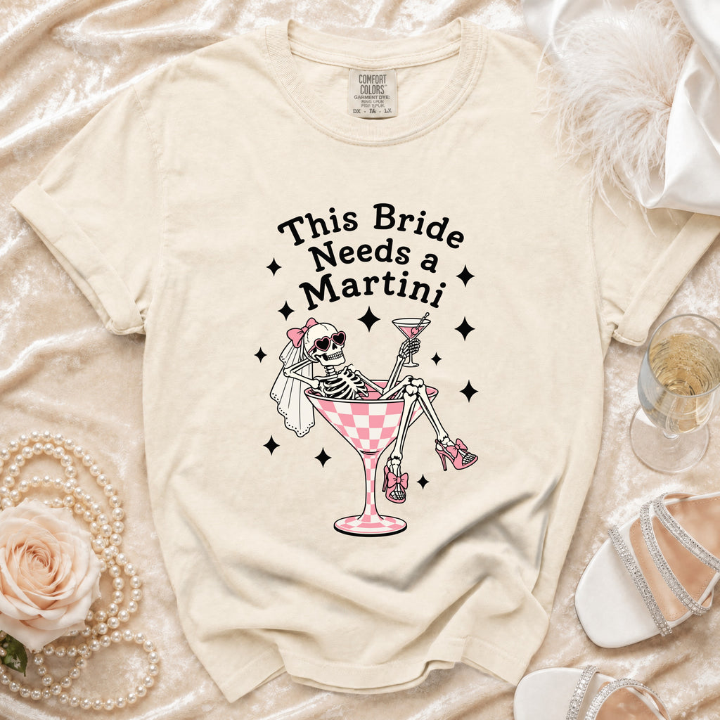 Skeleton bride graphic on a cream t-shirt reading "This Bride Needs a Martini."