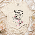 Skeleton bride graphic on a cream t-shirt reading "This Bride Needs a Martini."