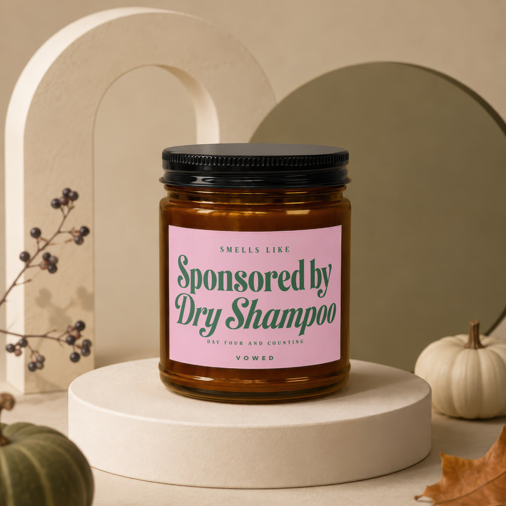 Amber jar candle with "Sponsored by Dry Shampoo" text on pink label.
