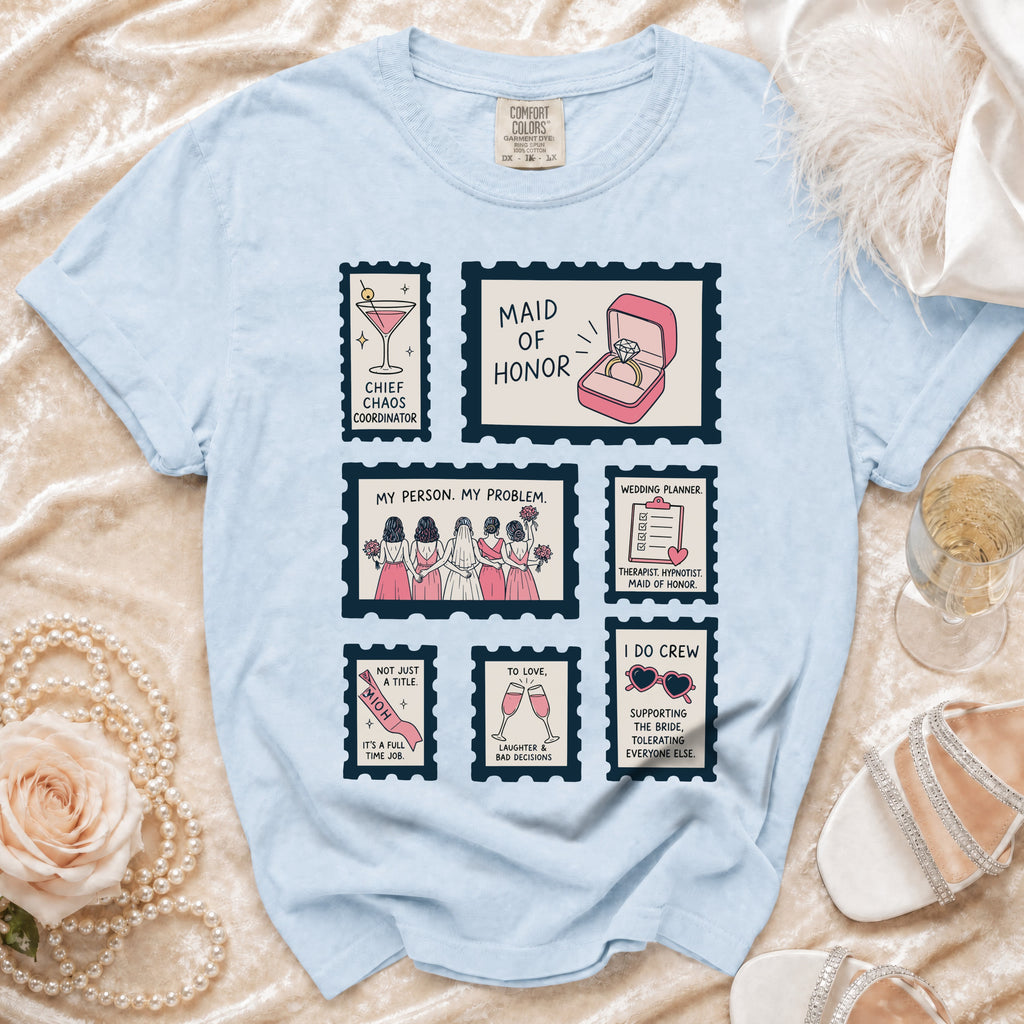Light blue t-shirt with "Maid of Honor" themes in stamp graphics.