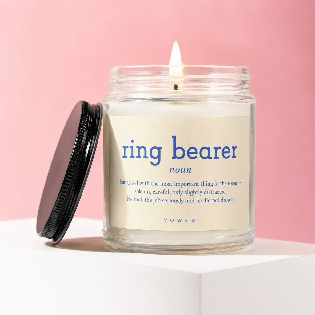 Glass jar candle with "ring bearer" definition and VOWED logo.
