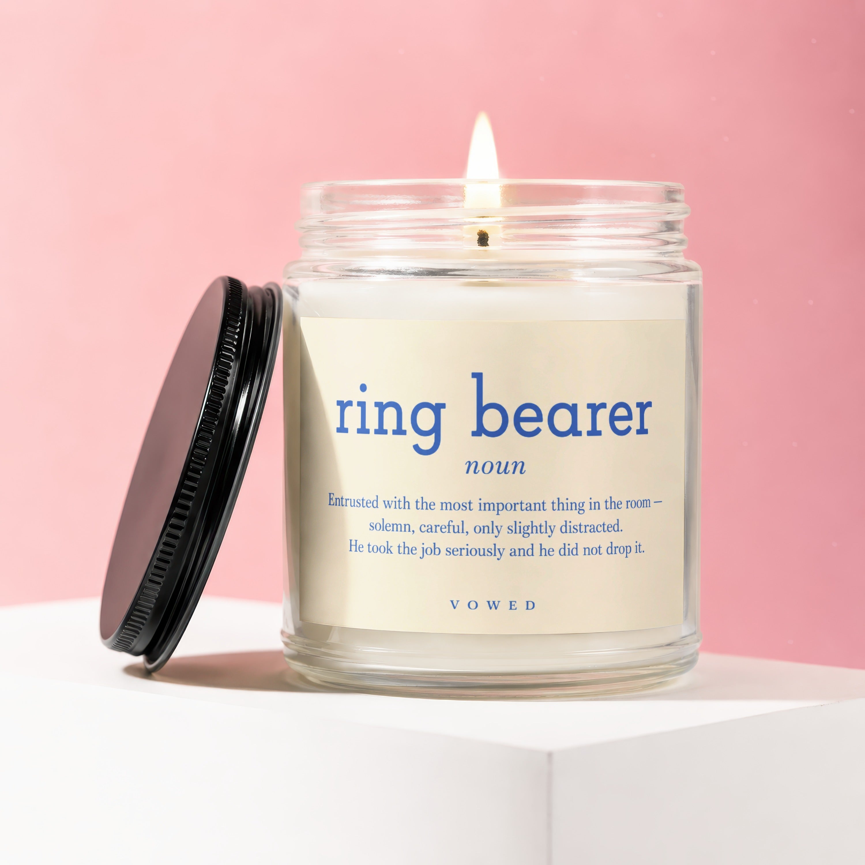 Glass jar candle with "ring bearer" definition and VOWED logo.