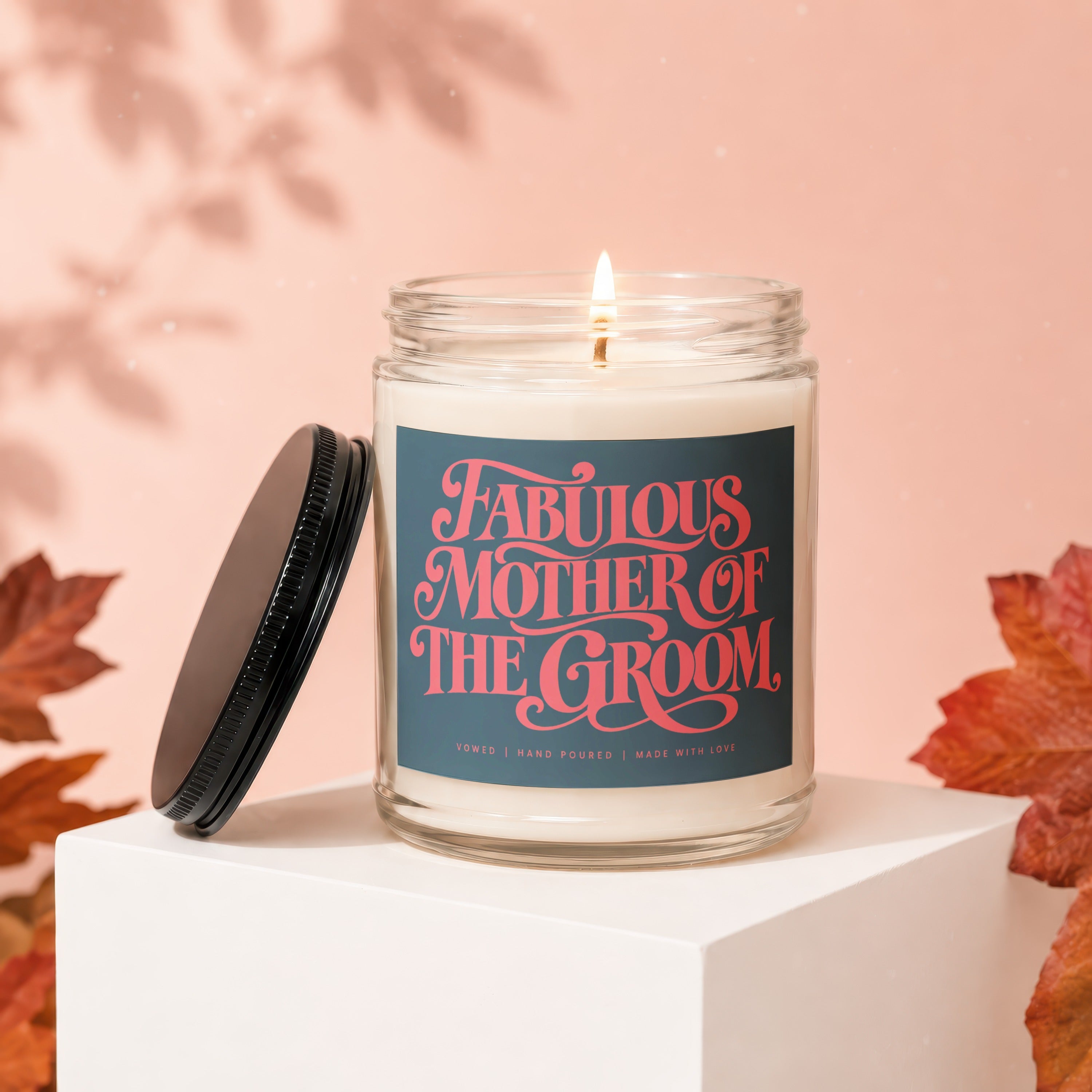 Candle with label "Fabulous Mother of the Groom" on a white pedestal.