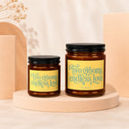 Two candles with yellow labels reading "Two grooms, endless love" and "VOWED".