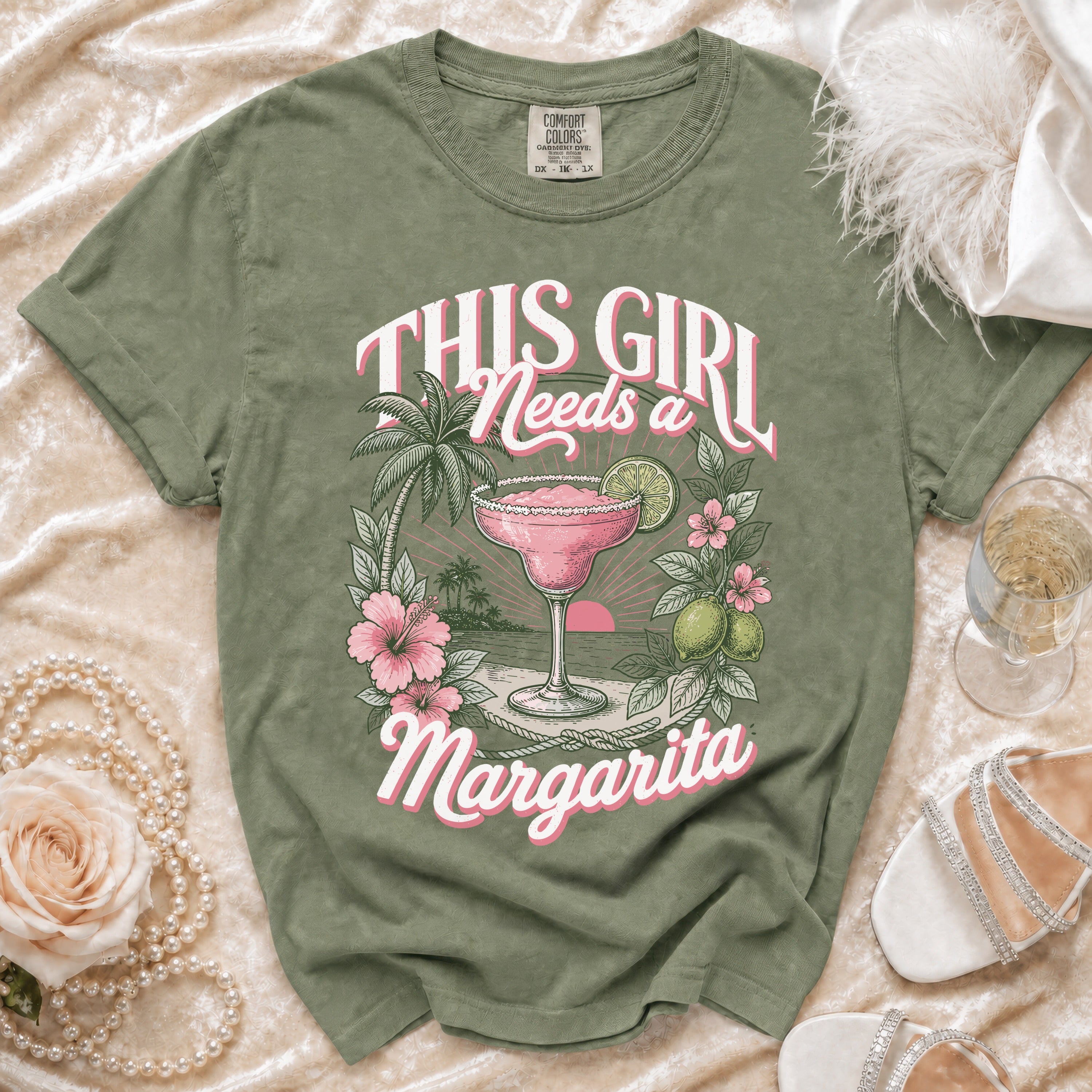 Olive green t-shirt with "This Girl Needs a Margarita" graphic.