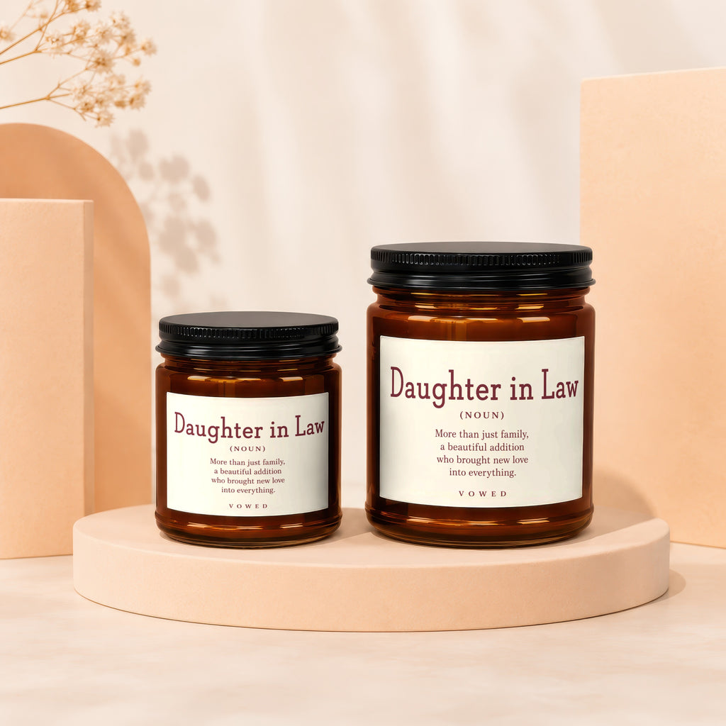 Two brown glass candles labeled "Daughter in Law" with definition text.