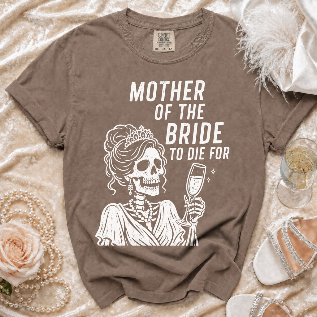 Brown t-shirt with white graphic of a skeleton bride holding champagne and text "Mother of the Bride To Die For".
