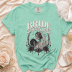 Teal t-shirt with a skeleton bride design and text "Bride After Dark".