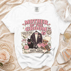 White t-shirt with "Mother of the Groom" design featuring a cat, bear, and suit.