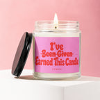Glass jar candle with pink label reading "I've Been Given Earned This Candle"