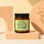 Brown candle in a jar with a lime green label reading "DOUBLE PROPOSAL ENERGY VOWED".