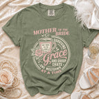 Green t-shirt with "Mother of the Bride, Surviving Grace and Group Chats" graphic.