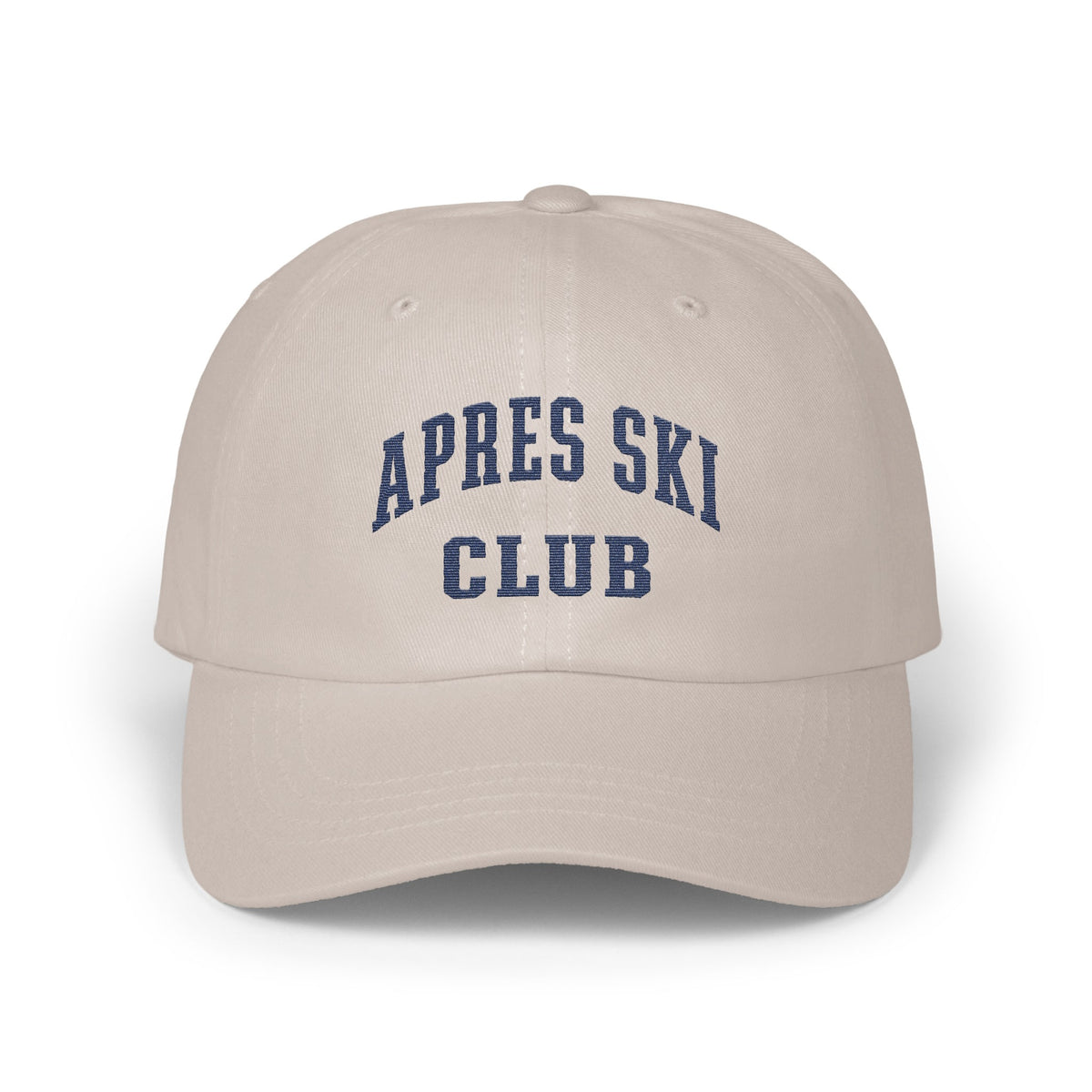 Light beige baseball cap featuring embroidered blue collegiate-style text reading APRES SKI CLUB on the front.