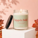 Lit candle in jar, "Engaged & Thrilled" text, "VOWED" logo.