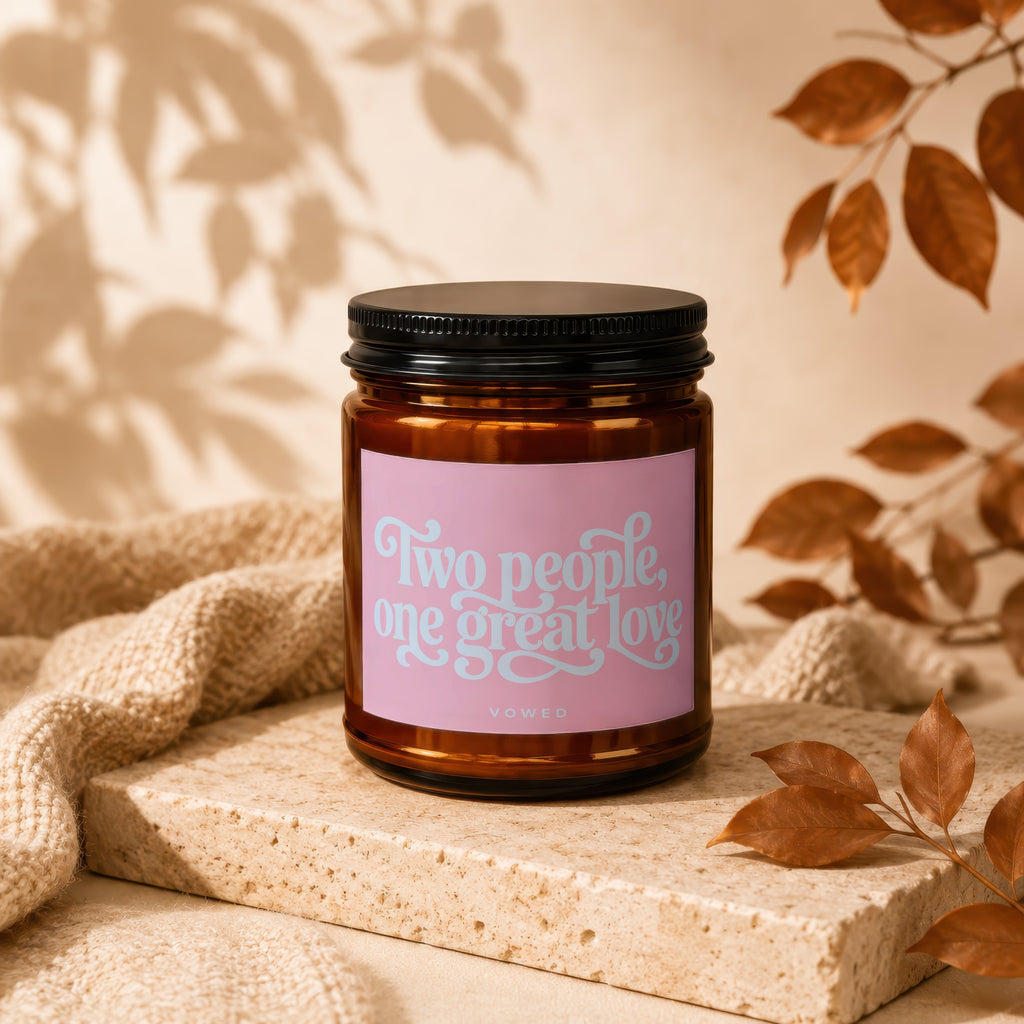 Candle with pink label reading "Two people, one great love" and "VOWED".