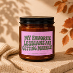 Amber jar candle with a pink label that reads "My Favorite Lesbians Are Getting Married!".