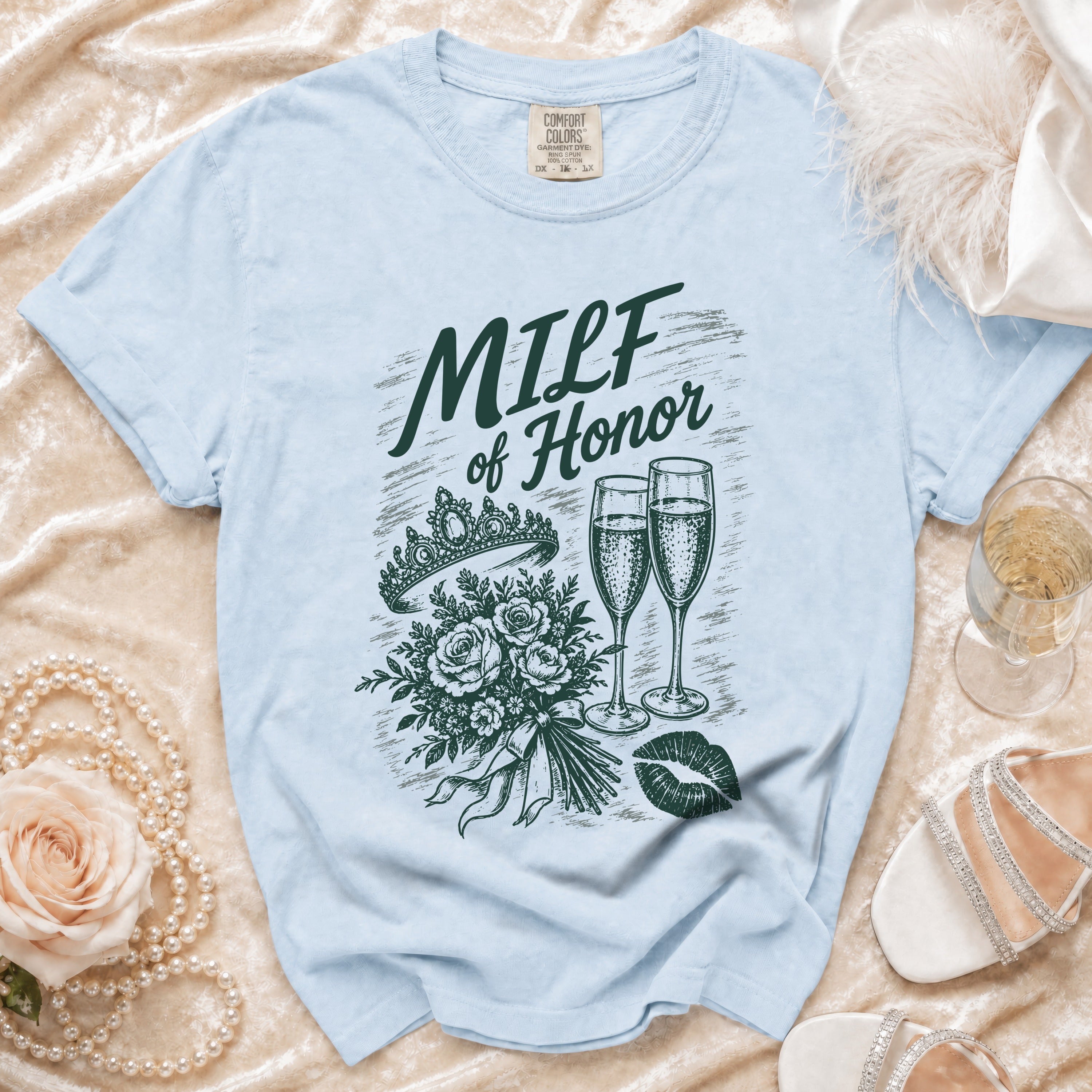 Light blue t-shirt with "MILF of Honor" design featuring a tiara, bouquet, champagne glasses, and lips.