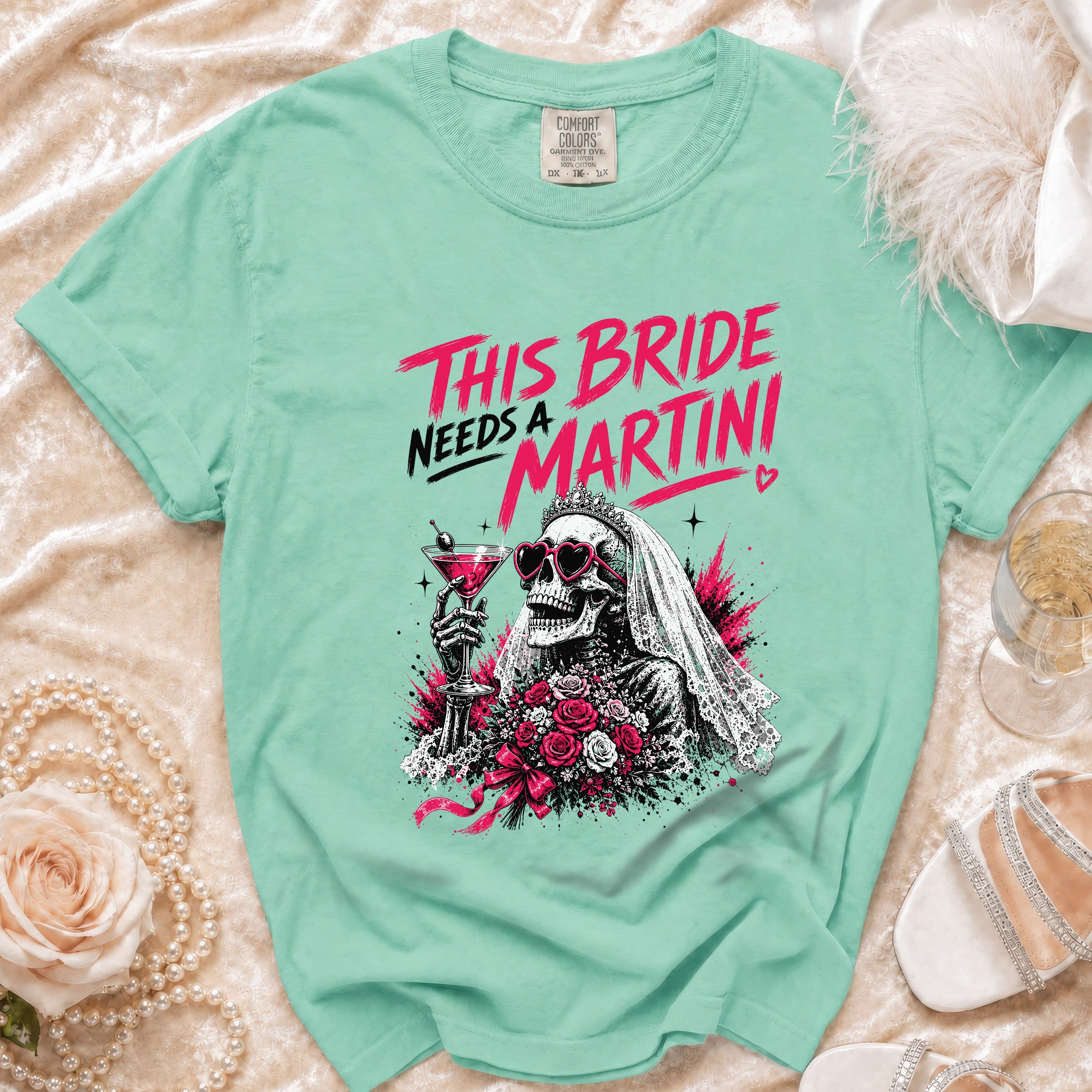 Mint t-shirt with skeleton bride graphic and "THIS BRIDE NEEDS A MARTINI" text.